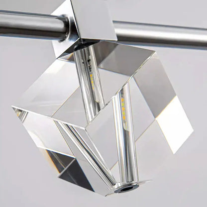 A modern decorbites crystal chandelier with faceted glass panels and chrome finish for living and dining rooms