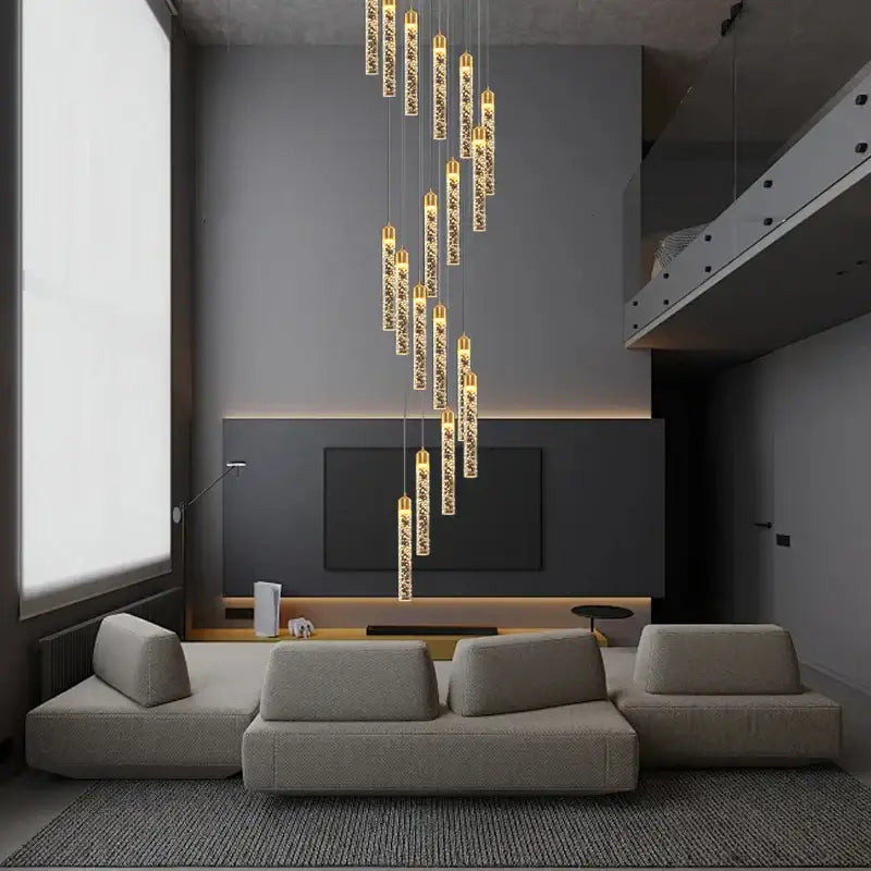 A decorbites crystal chandelier with cylindrical glass pendants and golden tops for circular stairwell lighting