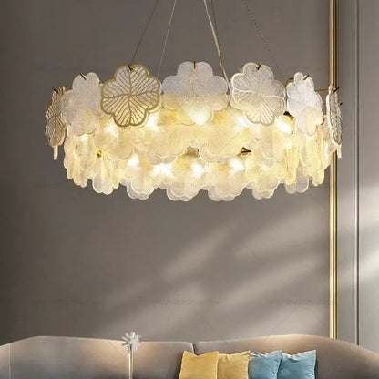 Elegant decorbites crystal chandelier with layered translucent glass petals and gold leaf accents emitting warm light