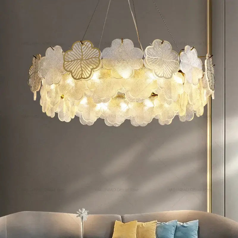 Elegant decorbites crystal chandelier with layered translucent glass petals and gold leaf accents emitting warm light