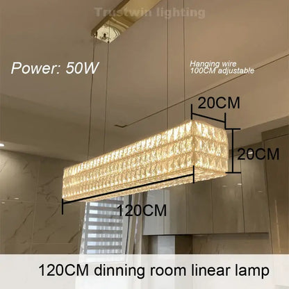 A 120cm DecorBites crystal chandelier with rectangular crystal design emitting warm golden light for dining rooms