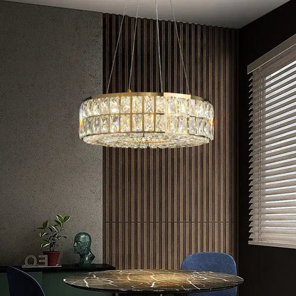 A modern decorbites crystal chandelier with gold frame and faceted crystal prisms for living and dining rooms