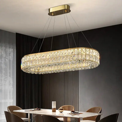 Gold-toned decorbites crystal chandelier featuring multiple rows of clear faceted crystals for living and dining rooms