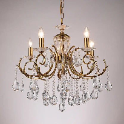 Gold-toned decorbites crystal chandelier with intricate curved arms and clear crystal droplets for luxury lighting