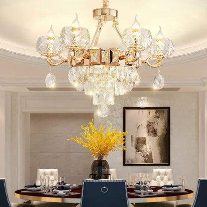 A luxurious gold-toned decorbites crystal chandelier with crystal droplets and faceted glass shades for grand european interiors