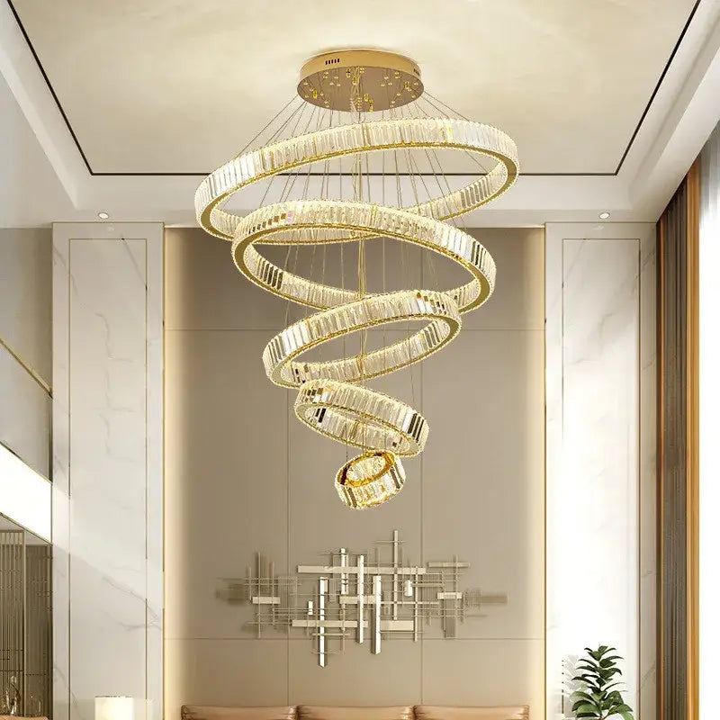 A modern decorbites crystal chandelier with concentric clear crystal rings and gold metal for stair lighting
