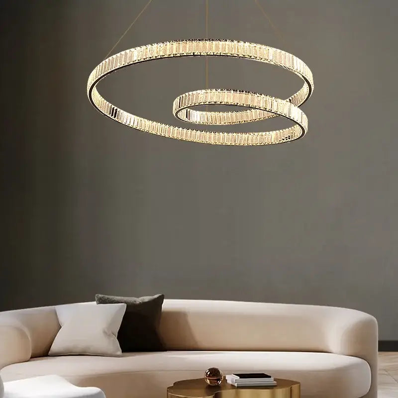 Gold-toned decorbites crystal chandelier led light fixture with two interlocking rings and faceted crystal accents