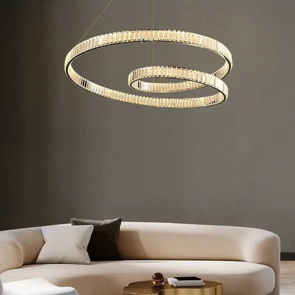 Gold-toned decorbites crystal chandelier led light fixture with two interlocking rings and faceted crystal accents