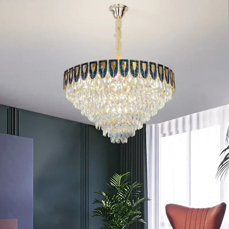 Luxurious decorbites crystal chandelier with tiered clear crystals and ornate blue gold border for modern living room