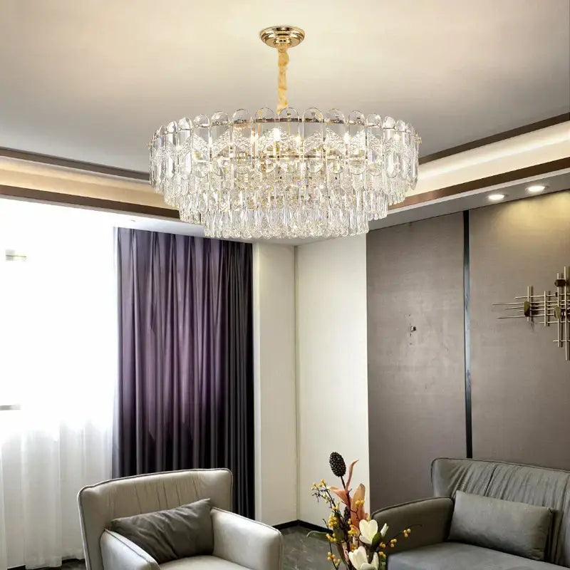 A decorbites crystal chandelier with a gold-toned fixture and clear glass prisms for modern luxury lighting