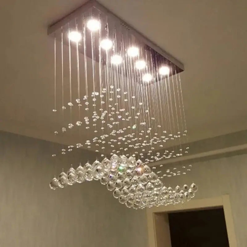A modern decorbites crystal chandelier led pendant light with clear crystal beads and metallic frame for living room use