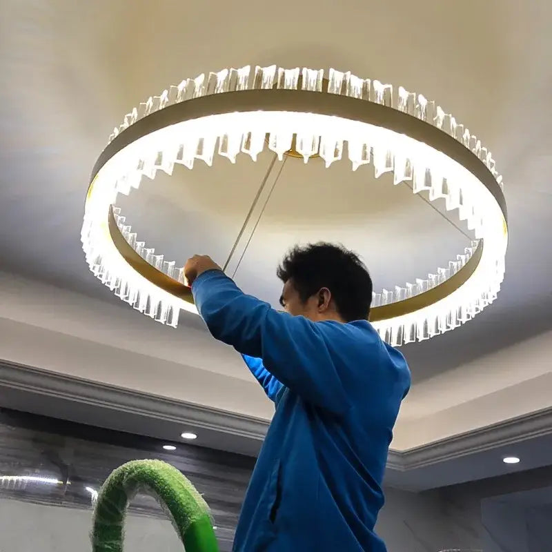 Modern gold-toned metal decorbites crystal chandelier led with clear faceted crystals in concentric rings for dining room decor
