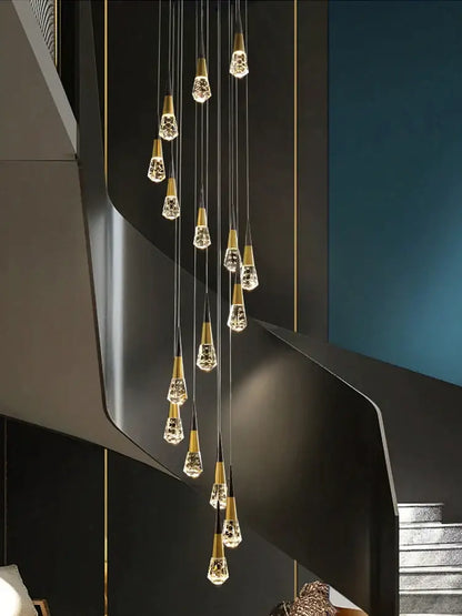 A decorbites crystal chandelier led with gold-toned metal and clear crystal teardrops for staircase and living areas