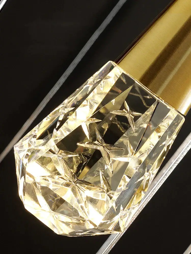 Faceted transparent crystal cap with star-shaped cutouts and gold-toned base on decorbites crystal chandelier led staircase lamp