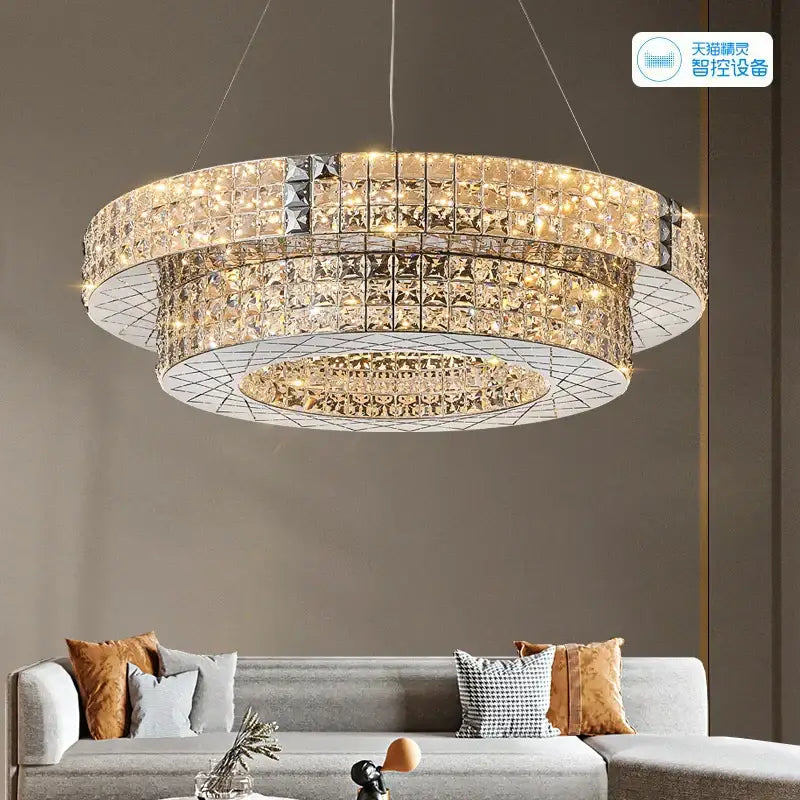 A modern double tiered decorbites crystal chandelier with warm golden lights and sleek metallic frame for luxury living room