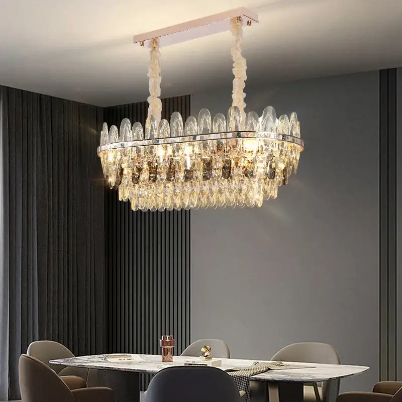 A modern decorbites crystal chandelier light with clear crystal droplets and polished chrome frame for luxury spaces