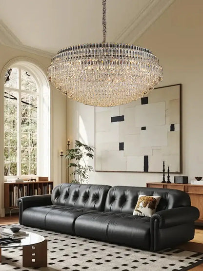 Large circular decorbites crystal chandelier lights featuring clear crystal prisms in concentric rings with metallic chain suspension