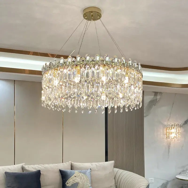 Luxurious gold-toned decorbites crystal chandelier with cascading clear crystal prisms for luxe living room decor