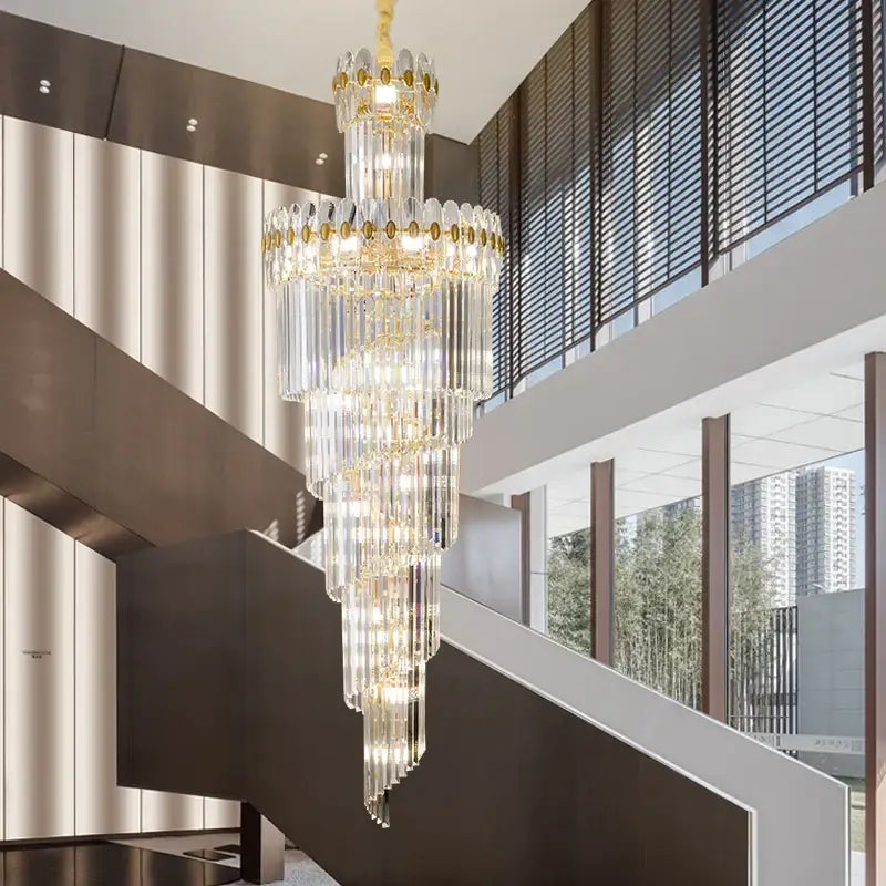 A DecorBites crystal chandelier with cascading crystal prisms and gold accents for luxe stairwell or living room lighting
