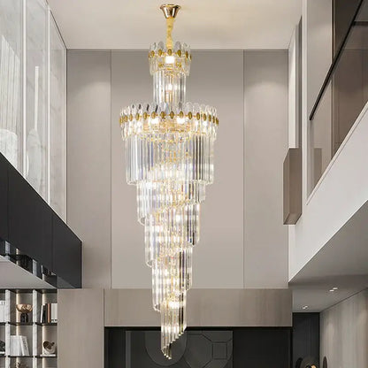 A decorbites crystal chandelier with gold-toned metal and clear glass prisms for luxe stairwell lighting fixture