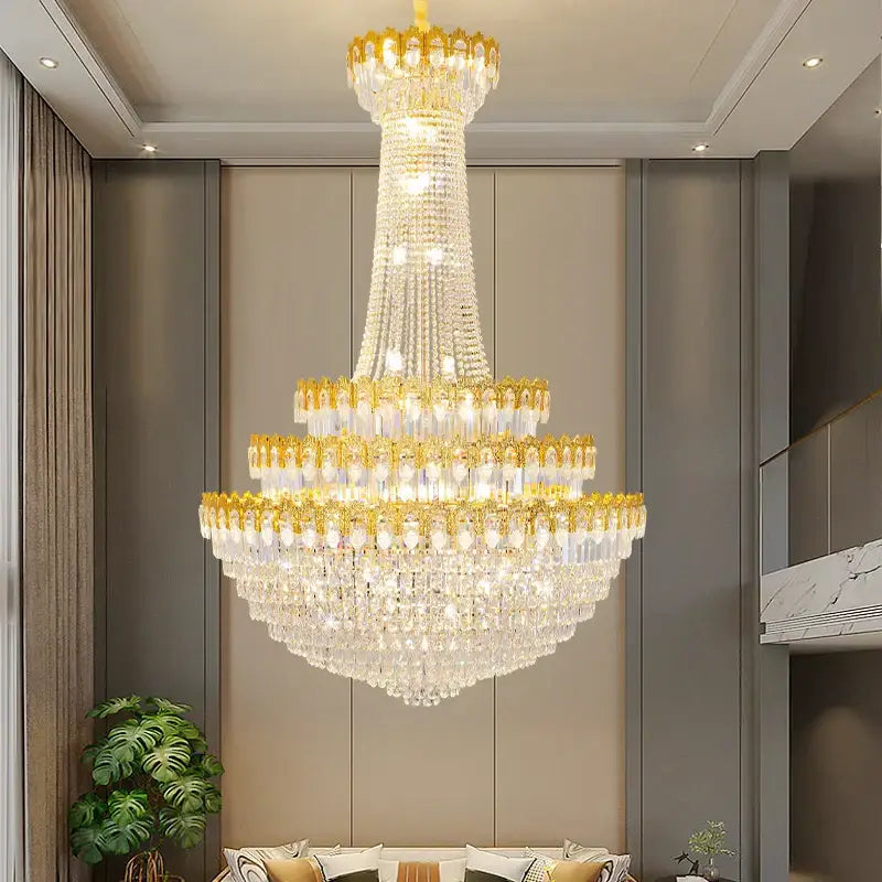 A multi-tiered decorbites crystal chandelier with gold-toned accents and clear crystals for luxury living rooms