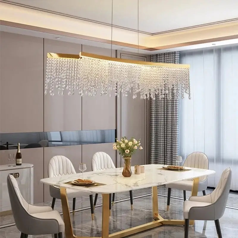 Gold-toned decorbites crystal chandelier featuring rectangular LED pendant light with cascading crystal droplets