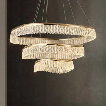 Gold-toned DecorBites crystal chandelier with spiral design and cascading crystal tiers for luxury LED lighting