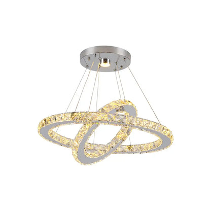 Modern chrome-finished decorbites crystal chandelier with interlocking crystal rings emitting warm golden light for living room