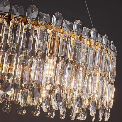 A luxurious gold-toned decorbites crystal chandelier with cascading clear crystal prisms for elegant living rooms and bedrooms