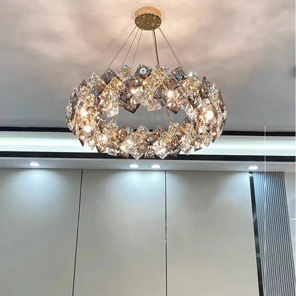 A modern decorbites crystal chandelier featuring faceted crystals arranged in a ring around a gold-toned fixture