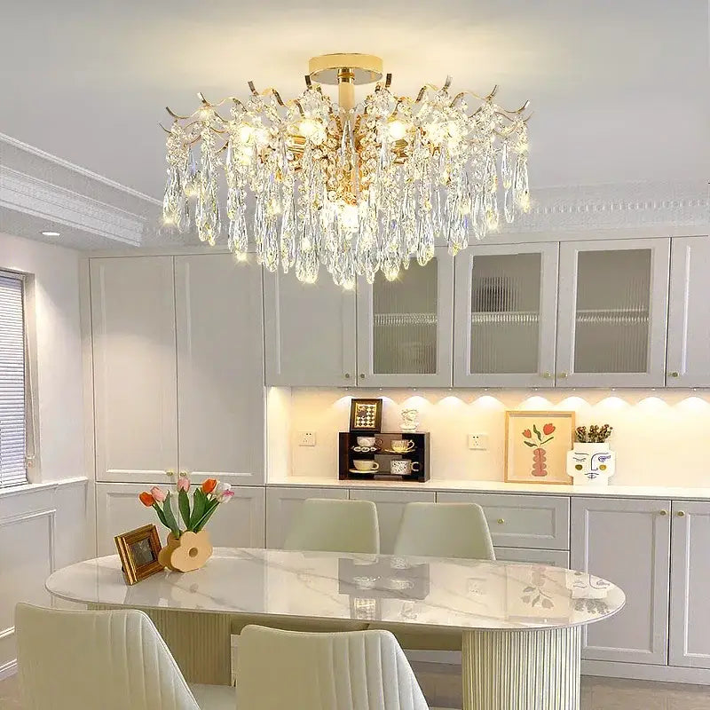A luxurious gold-toned decorbites crystal chandelier with cascading crystal droplets for elegant living space lighting