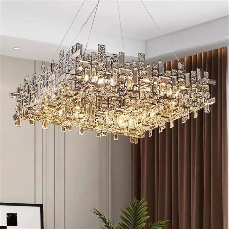 A modern rectangular decorbites crystal chandelier with clear and gold-toned prisms for living and dining rooms