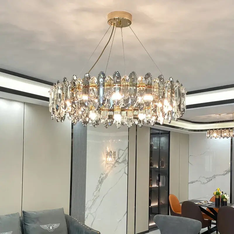 A modern decorbites crystal chandelier with clear crystal droplets and gold-toned metal for living room use