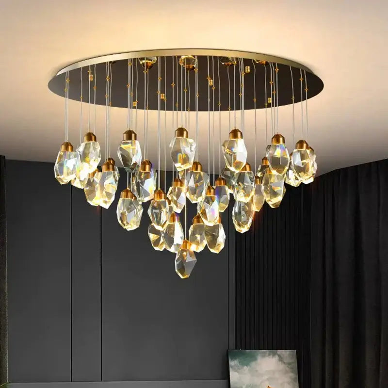 Modern decorbites crystal chandelier with faceted clear glass pendants and gold metal fixtures for living and dining rooms