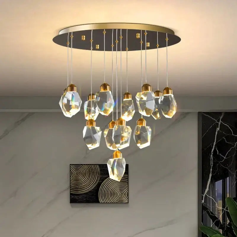 A modern decorbites crystal chandelier with gold-toned accents and faceted glass pendants for living and dining rooms