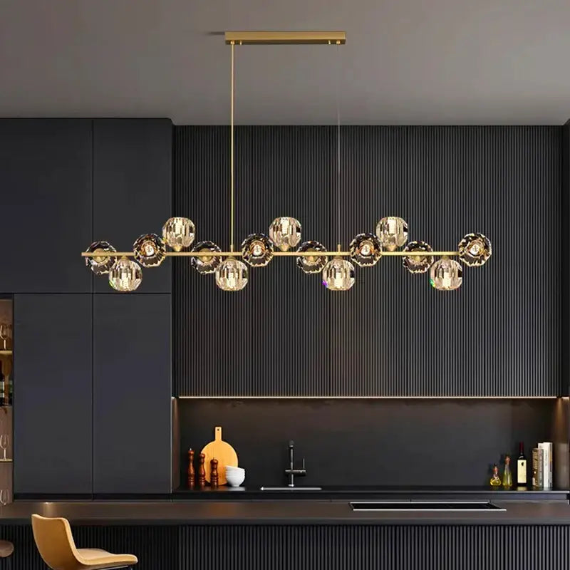 Gold-toned decorbites crystal chandelier with multiple spherical glass bulbs for living and dining room lighting