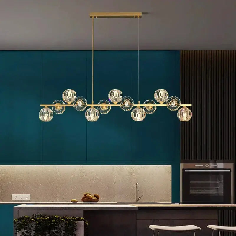 Gold-toned decorbites crystal chandelier with faceted crystal globe pendants for living and dining room luxury lighting