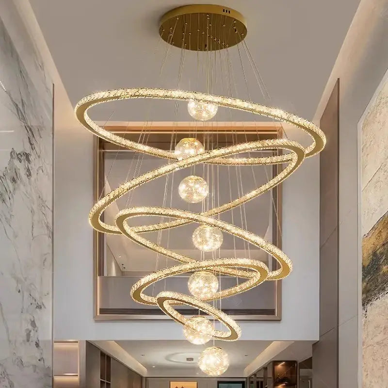 Golden spiral decorbites crystal chandelier featuring crystal-encrusted rings and spherical lights for indoor lighting