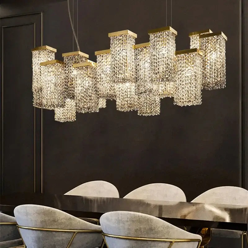 Gold-toned decorbites crystal chandelier with cascading crystal prisms in a modern 3D rectangular cluster design