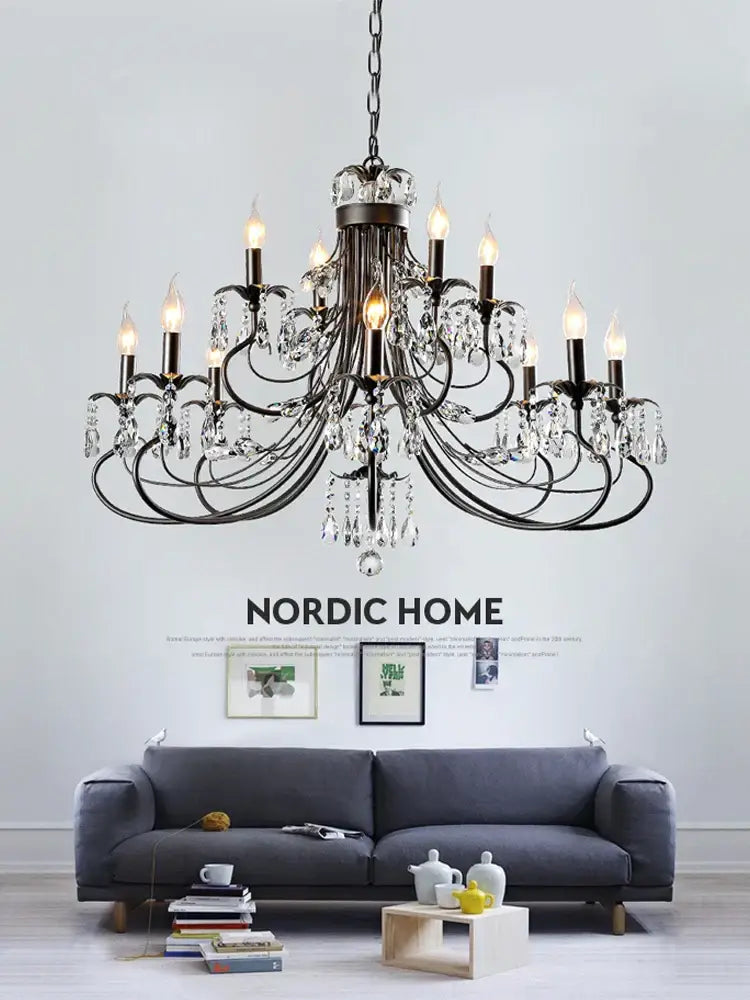 An ornate black wrought iron decorbites crystal chandelier with candle-style bulbs and crystal droplets for living room use