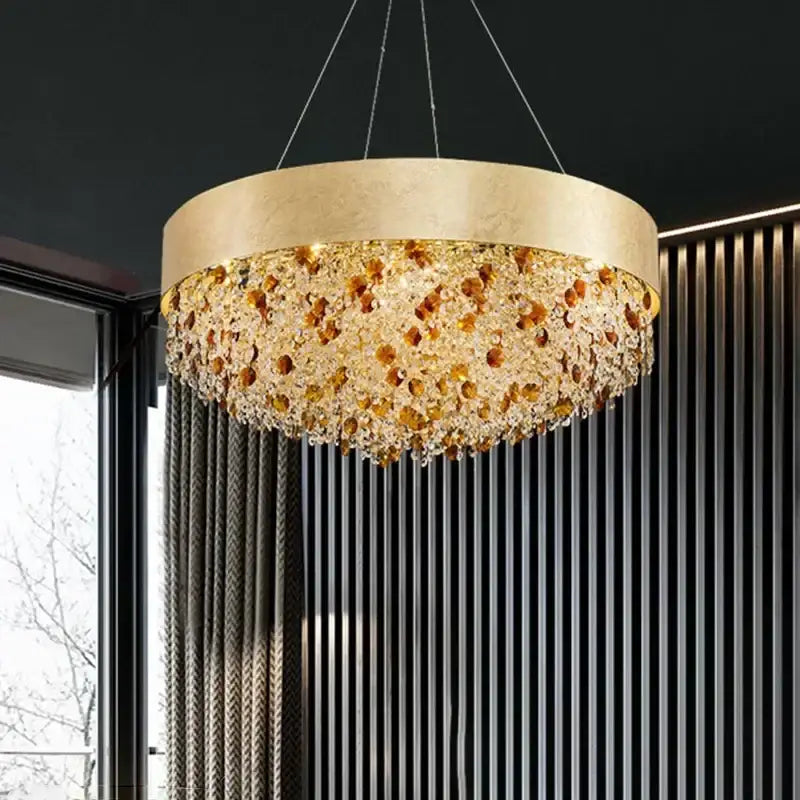 A decorbites crystal chandelier with a gold-toned circular frame and cascading amber and clear glass beads for living rooms