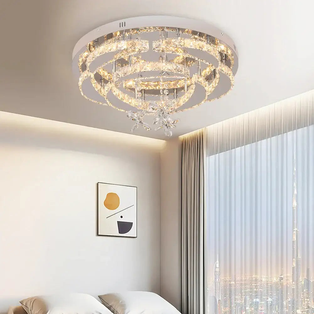 Decorbites crystal chandelier featuring multi-tiered faceted crystals with a sleek white base for living rooms