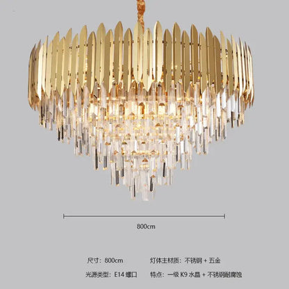 Gold-toned decorbites crystal chandelier with cascading clear crystal prisms and polished metallic blades for modern interiors