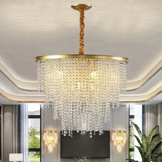 A luxuriously gold-toned decorbites crystal chandelier with cascading clear crystal droplets for modern elegance