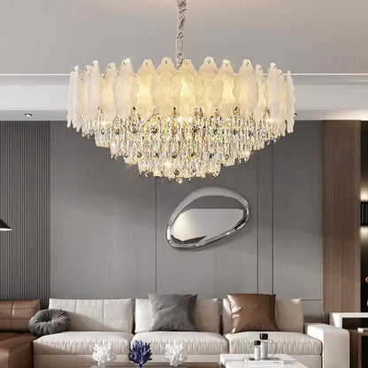 Decorbites crystal chandelier with circular design featuring white glass feathers and clear crystal droplets for modern elegance