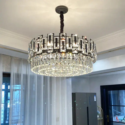 A decorbites crystal chandelier with a dark metal frame, rectangular crystal panels, and cascading clear glass prisms