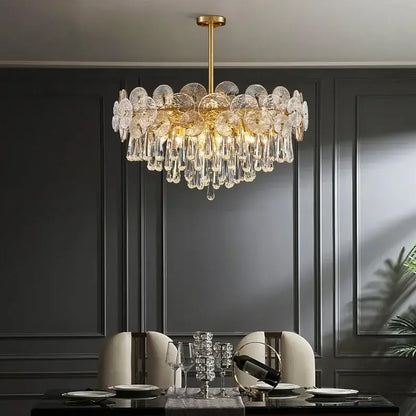 A luxurious gold-toned decorbites crystal chandelier with intricate crystal petals and teardrop crystals for living rooms