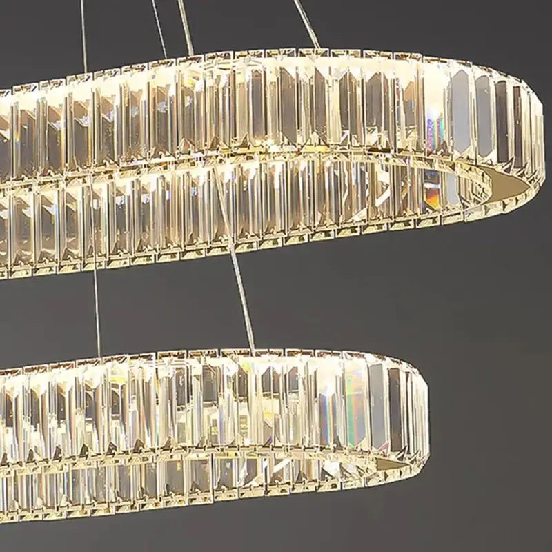 A modern decorbites crystal chandelier with clear faceted rods and gold-toned accents for living and dining rooms
