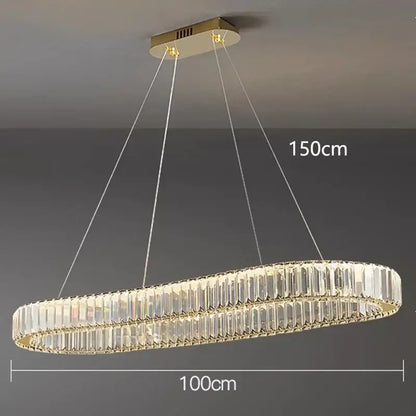 A modern decorbites crystal chandelier with oval gold frame and two concentric rings of clear crystal prisms for living room