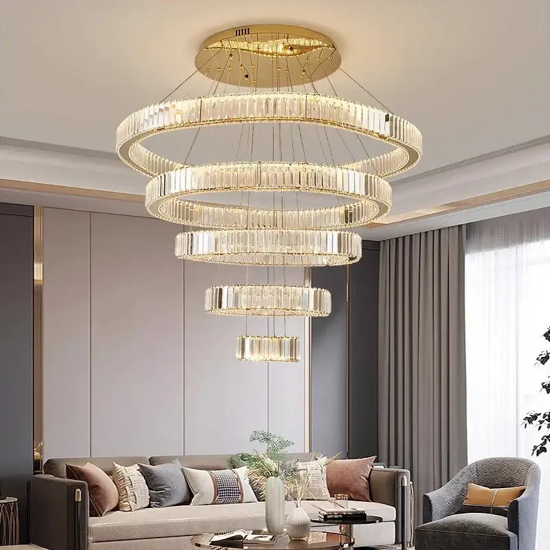Decorbites crystal chandelier with gold-toned metal frame and cascading clear crystal rings for modern home lighting